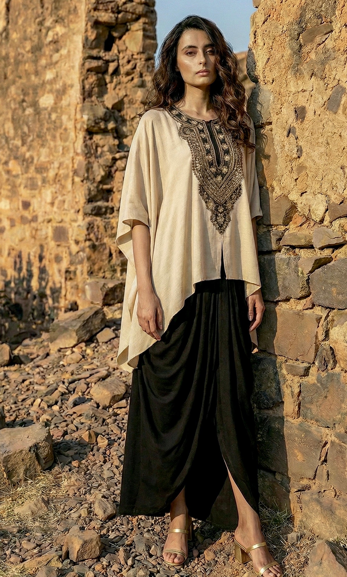 Begum in beige with black dhoti pant